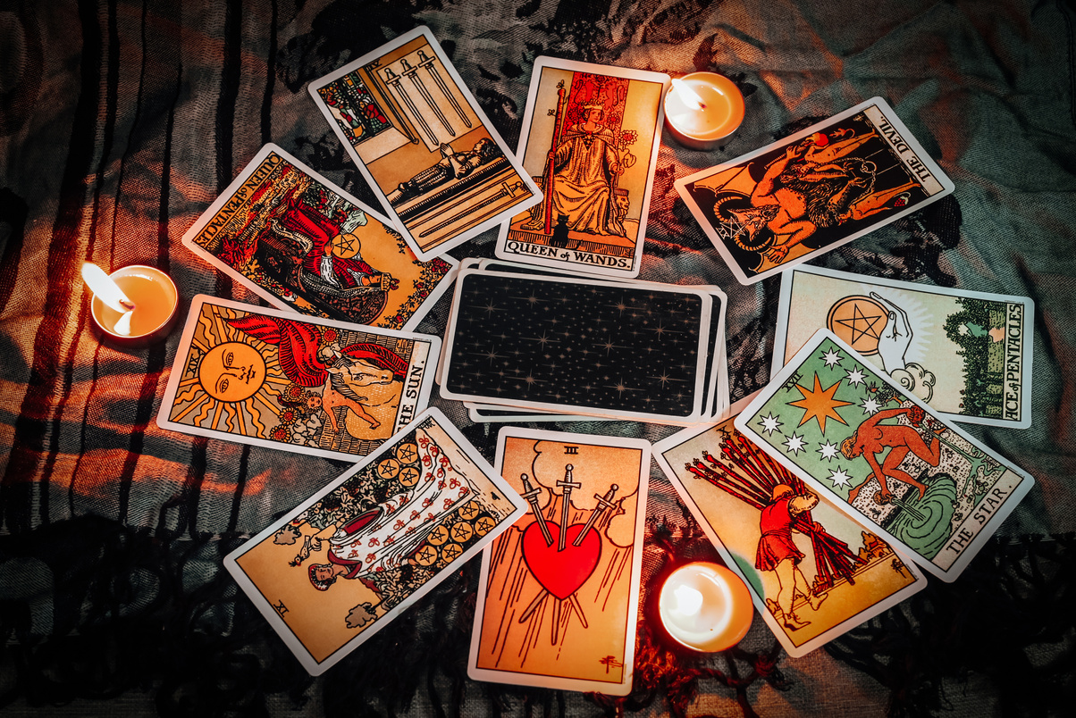 Tarot reading with tarot card background and candlelight on