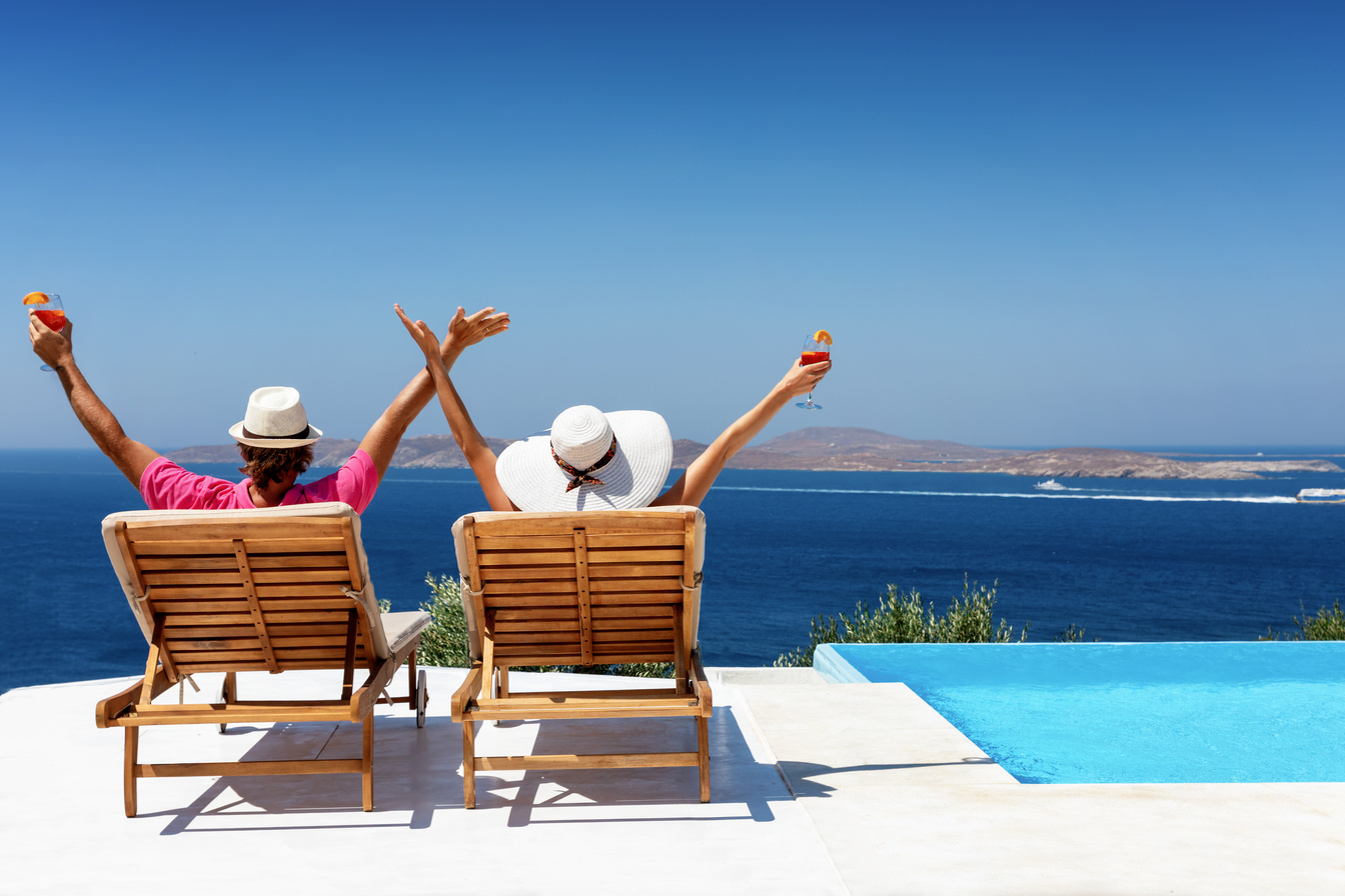 Couple enjoys their luxury vacation by the pool