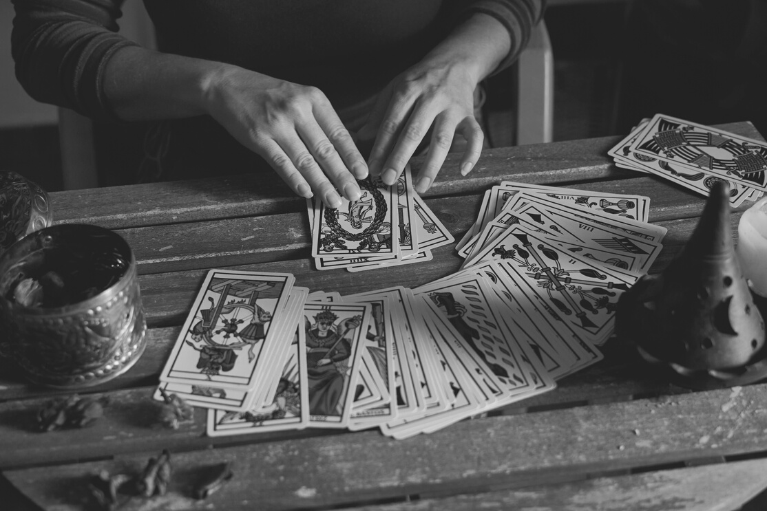Pythoness Woman Reading Tarot Cards on a Wooden Table