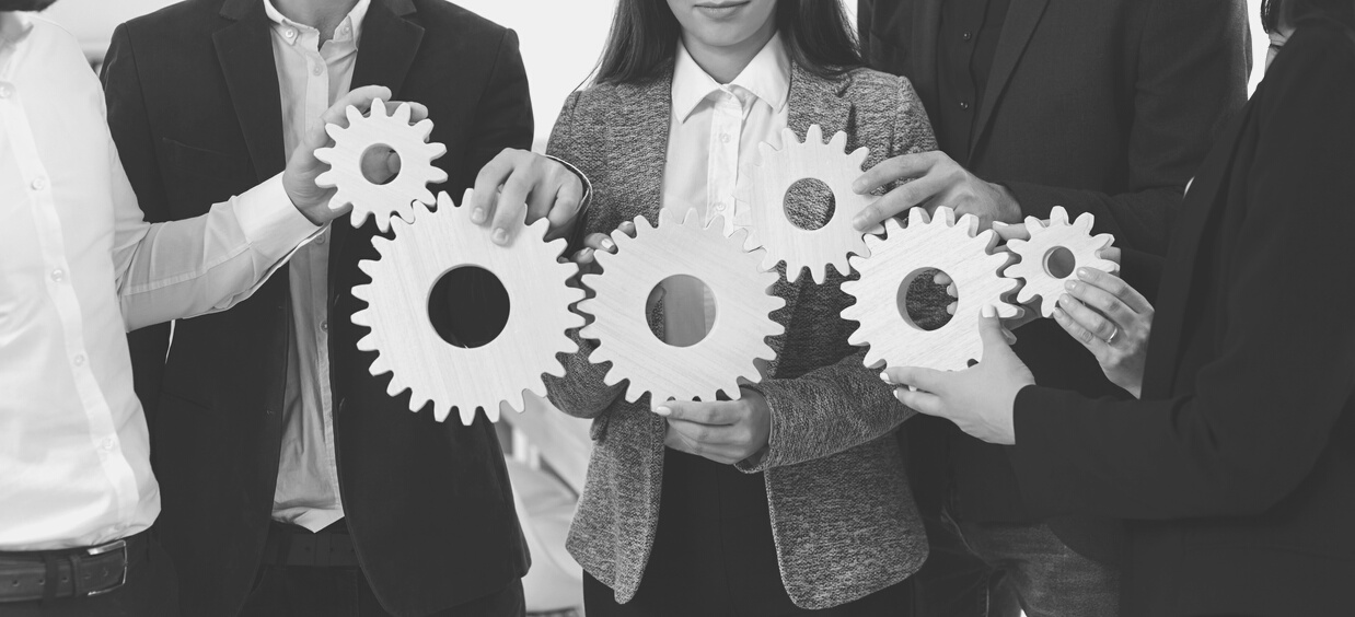 Company Employees Joining Gearwheels as Metaphor for Effective Business Management and Teamwork